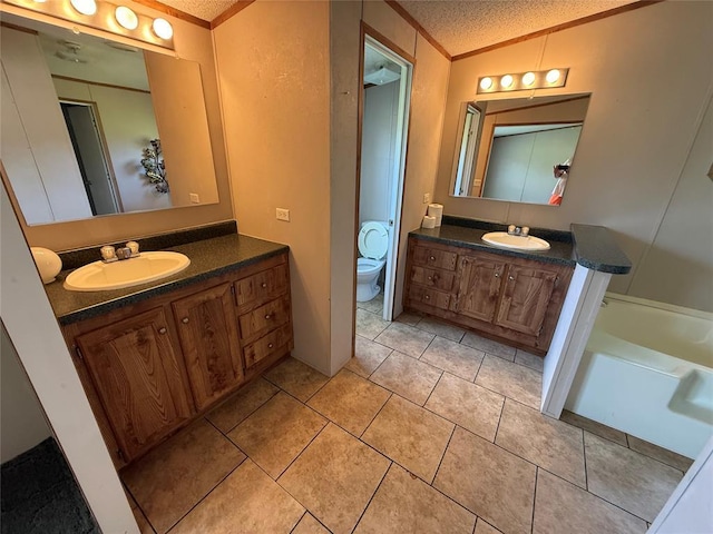 339133 E 870th Rd, Chandler, OK 74834 - bathroom with crown molding, vanity, tile patterned floors, a bathtub, and a textured ceiling