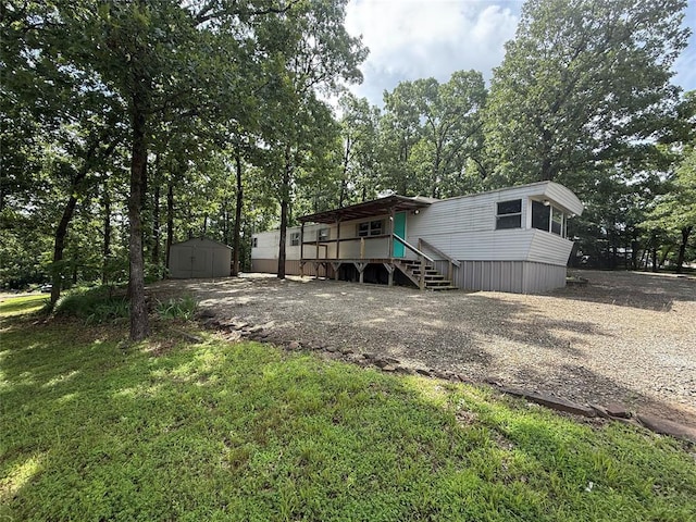120347 S 4186th Rd, Eufaula, OK 74432 - rear view of house with a storage unit, gravel driveway, and stairs