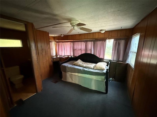 120347 S 4186th Rd, Eufaula, OK 74432 - bedroom with wood walls, carpet floors, a ceiling fan, and a textured ceiling