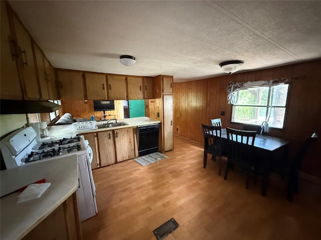 120347 S 4186th Rd, Eufaula, OK 74432 - kitchen featuring dishwasher, white gas range oven, under cabinet range hood, brown cabinets, and wooden walls