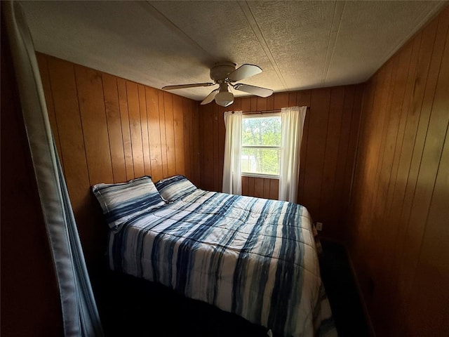 120347 S 4186th Rd, Eufaula, OK 74432 - bedroom with wood walls, a textured ceiling, and ceiling fan