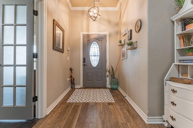 2432 NW 175th St, Edmond, OK 73012 - foyer entrance featuring dark wood finished floors, ornamental molding, and a chandelier