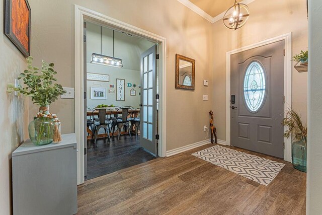 2432 NW 175th St, Edmond, OK 73012 - entryway with wood finished floors, ornamental molding, and a chandelier