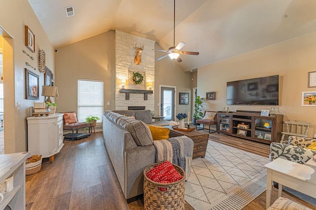 2432 NW 175th St, Edmond, OK 73012 - living area featuring wood finished floors, a fireplace, a ceiling fan, healthy amount of natural light, and high vaulted ceiling