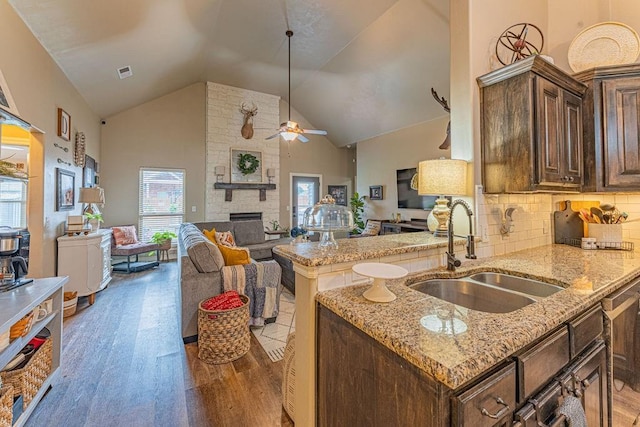 2432 NW 175th St, Edmond, OK 73012 - kitchen featuring open floor plan, a ceiling fan, light wood-style flooring, light stone countertops, and high vaulted ceiling