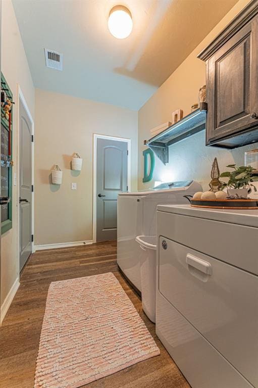 2432 NW 175th St, Edmond, OK 73012 - laundry room featuring cabinet space, dark wood finished floors, and washer and dryer