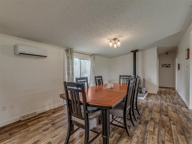 7401 E Forrest Hills Rd, Guthrie, OK 73044 - dining space with a wall mounted AC, wood finished floors, a textured ceiling, and crown molding