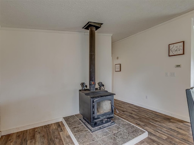 7401 E Forrest Hills Rd, Guthrie, OK 73044 - detailed view of wood finished floors, ornamental molding, a wood stove, and a textured ceiling