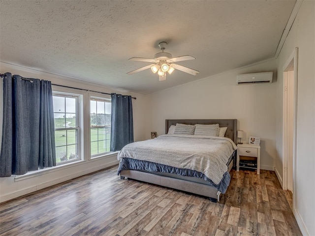 7401 E Forrest Hills Rd, Guthrie, OK 73044 - bedroom with a wall mounted air conditioner, wood finished floors, vaulted ceiling, a textured ceiling, and ornamental molding