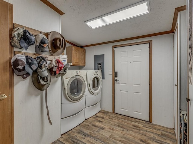 7401 E Forrest Hills Rd, Guthrie, OK 73044 - washroom with cabinet space, washing machine and dryer, wood finished floors, crown molding, and a textured ceiling