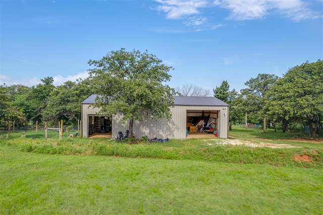 7401 E Forrest Hills Rd, Guthrie, OK 73044 - view of green lawn featuring an outbuilding and a garage