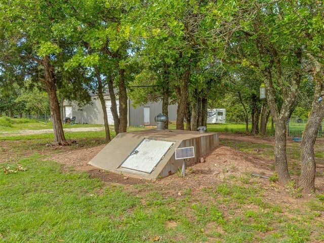 7401 E Forrest Hills Rd, Guthrie, OK 73044 - entry to storm shelter with a lawn