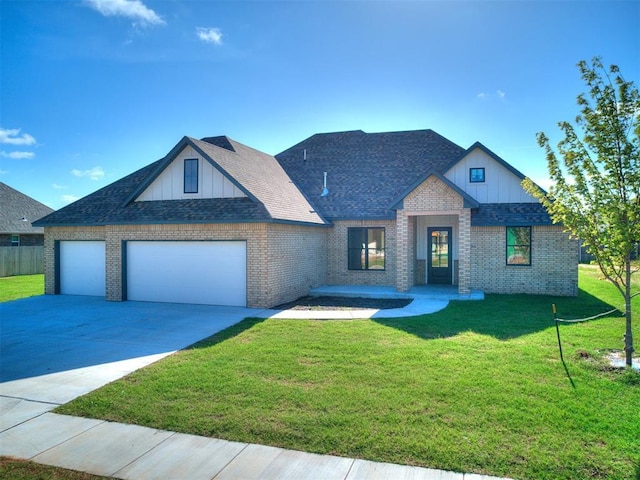 1136 Jozie Way, Tuttle, OK 73089 - view of front of property with board and batten siding, a front yard, an attached garage, brick siding, and driveway
