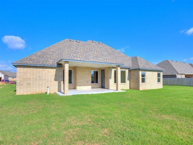 1136 Jozie Way, Tuttle, OK 73089 - back of house featuring brick siding, a patio area, and a shingled roof
