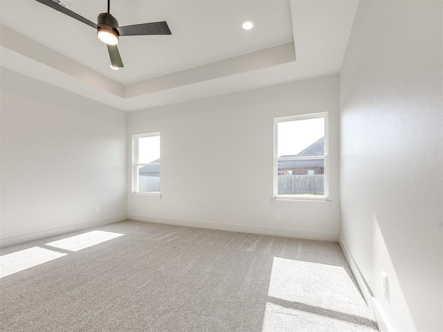 1136 Jozie Way, Tuttle, OK 73089 - spare room with light carpet, a tray ceiling, a ceiling fan, and recessed lighting