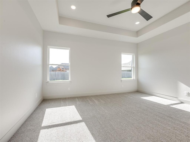 1136 Jozie Way, Tuttle, OK 73089 - unfurnished room with light carpet, a tray ceiling, a ceiling fan, and recessed lighting