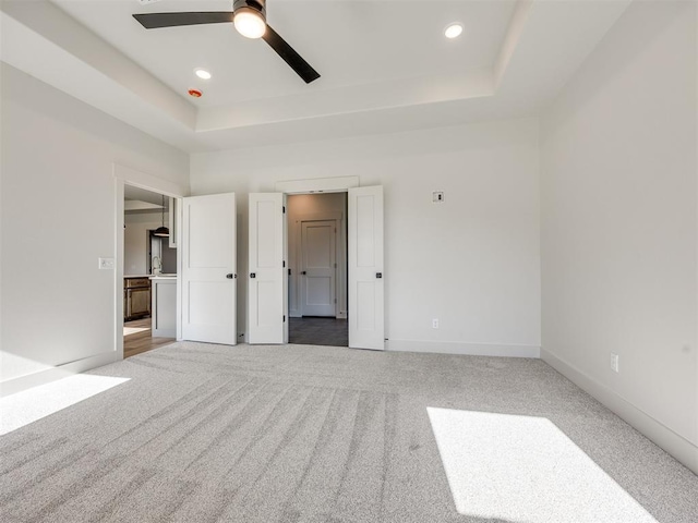1136 Jozie Way, Tuttle, OK 73089 - unfurnished bedroom featuring a raised ceiling, carpet flooring, recessed lighting, and ceiling fan