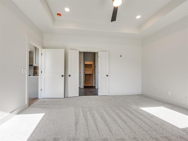 1136 Jozie Way, Tuttle, OK 73089 - unfurnished bedroom featuring a tray ceiling, carpet, recessed lighting, and ceiling fan