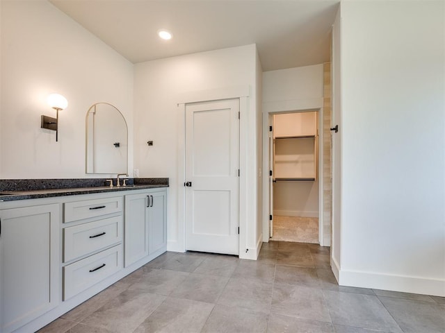 1136 Jozie Way, Tuttle, OK 73089 - bathroom featuring vanity, a walk in closet, and recessed lighting