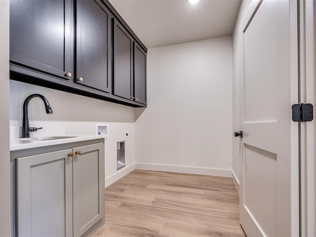 1136 Jozie Way, Tuttle, OK 73089 - laundry area featuring electric dryer hookup, cabinet space, hookup for a washing machine, and light wood-style flooring