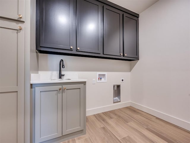 1136 Jozie Way, Tuttle, OK 73089 - washroom with electric dryer hookup, cabinet space, washer hookup, and light wood-style floors