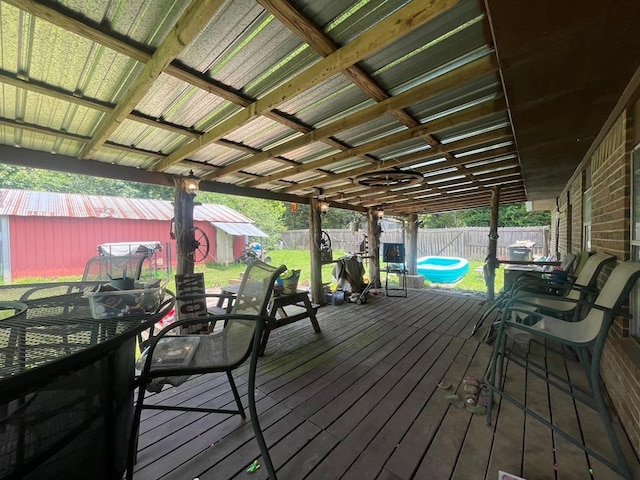 1003 Lukfata St, Broken Bow, OK 74728 - deck with a fenced backyard, outdoor dining area, and an outbuilding