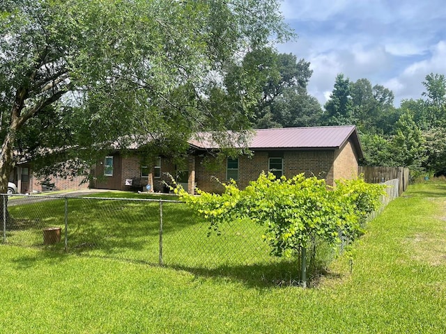 1003 Lukfata St, Broken Bow, OK 74728 - view of home's exterior featuring brick siding and a metal roof