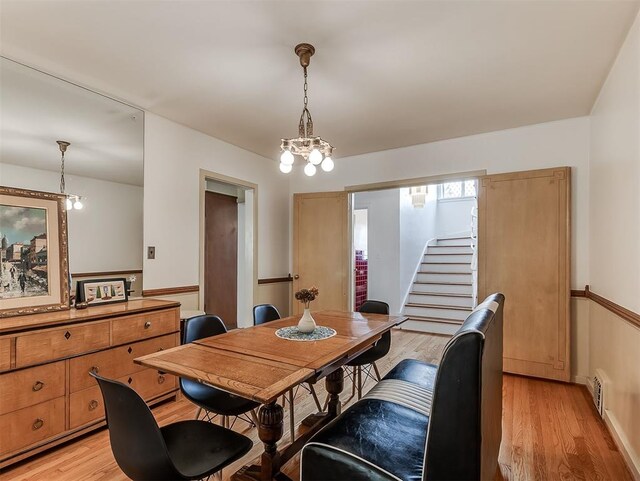 2720 NW 26th St, Oklahoma City, OK 73107 - dining area with stairway, light wood-style floors, and a chandelier