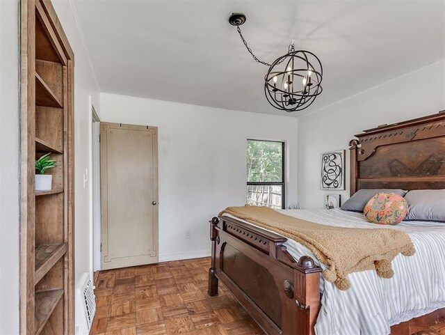 2720 NW 26th St, Oklahoma City, OK 73107 - bedroom featuring a chandelier and baseboards