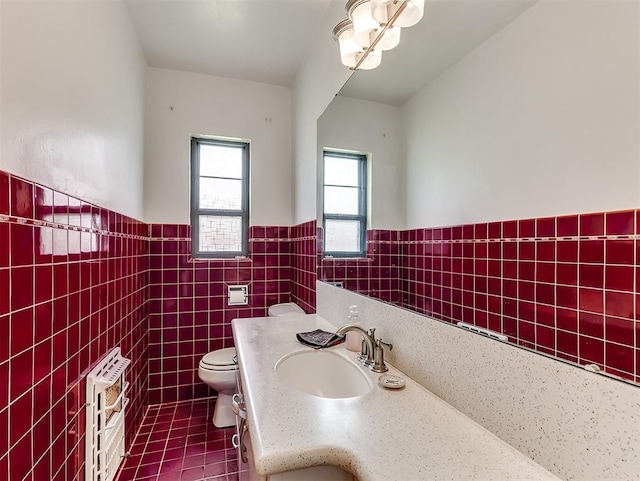 2720 NW 26th St, Oklahoma City, OK 73107 - bathroom with vanity, tile walls, heating unit, wainscoting, and tile patterned flooring