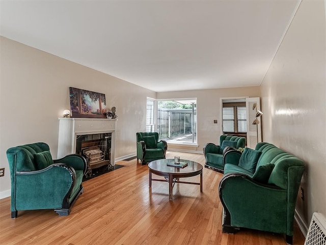 2720 NW 26th St, Oklahoma City, OK 73107 - living area featuring light wood finished floors and a fireplace with flush hearth