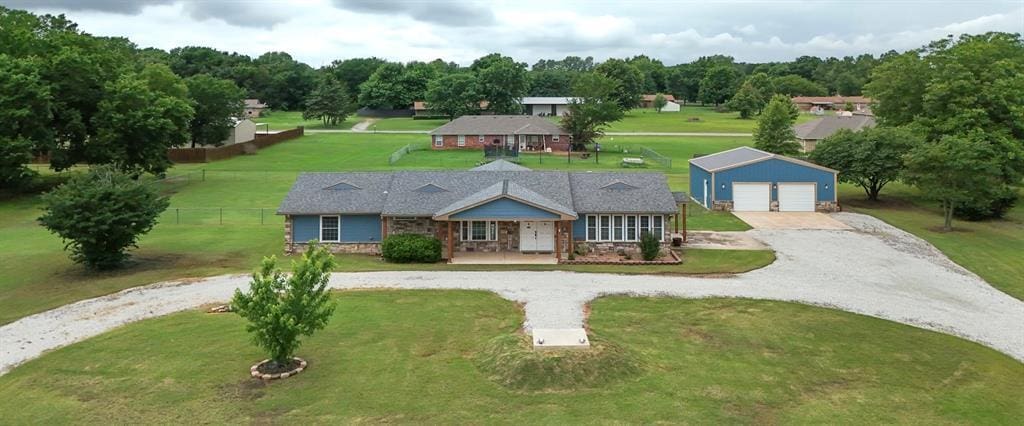 5504 Gemini St, Shawnee, OK 74804 - view of front of home featuring an outbuilding, curved driveway, covered porch, and stone siding