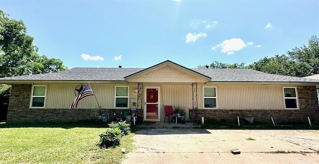 909 N Center St, Shawnee, OK 74801 - single story home featuring stone siding, a front lawn, and a shingled roof