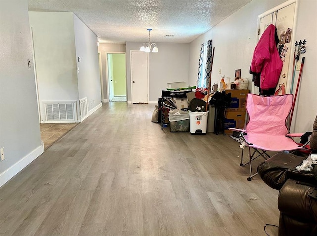 909 N Center St, Shawnee, OK 74801 - dining space with wood finished floors, a chandelier, and a textured ceiling