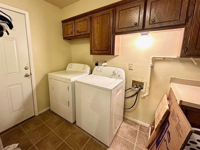 909 N Center St, Shawnee, OK 74801 - washroom with washer and clothes dryer, cabinet space, and dark tile patterned floors