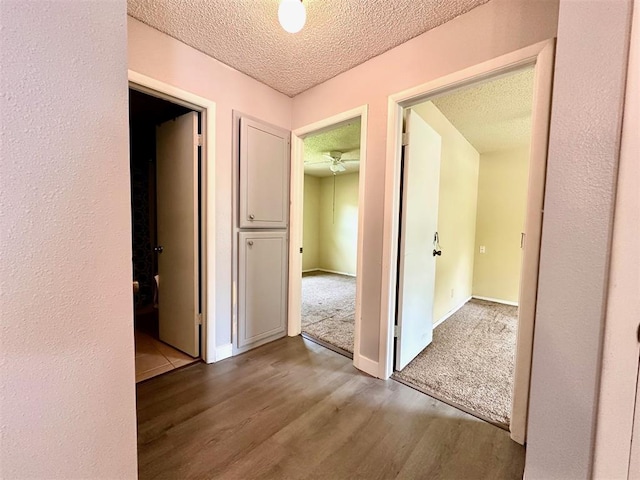 909 N Center St, Shawnee, OK 74801 - hallway with wood finished floors and a textured ceiling