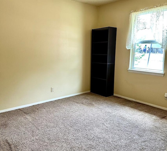 909 N Center St, Shawnee, OK 74801 - spare room featuring carpet