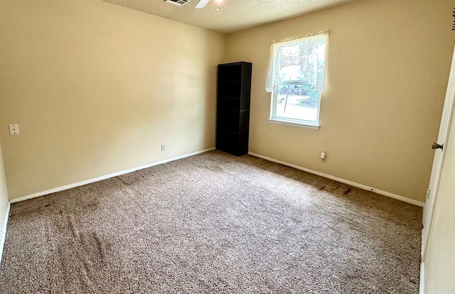 909 N Center St, Shawnee, OK 74801 - carpeted spare room featuring a textured ceiling and baseboards