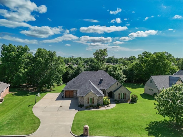 2309 Pinehurst Ct, Shawnee, OK 74801 - view of front facade featuring stone siding, concrete driveway, a front yard, and an attached garage
