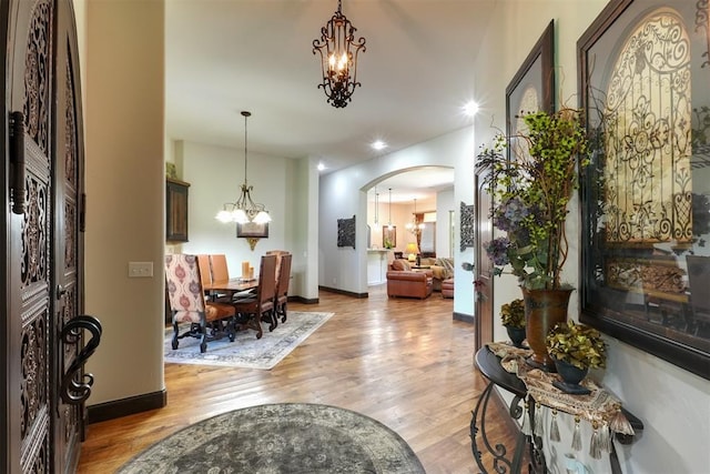 2309 Pinehurst Ct, Shawnee, OK 74801 - foyer with a chandelier, light wood-style floors, arched walkways, and recessed lighting