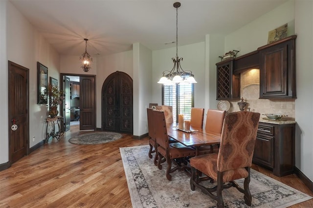 2309 Pinehurst Ct, Shawnee, OK 74801 - dining room with a chandelier and light wood finished floors