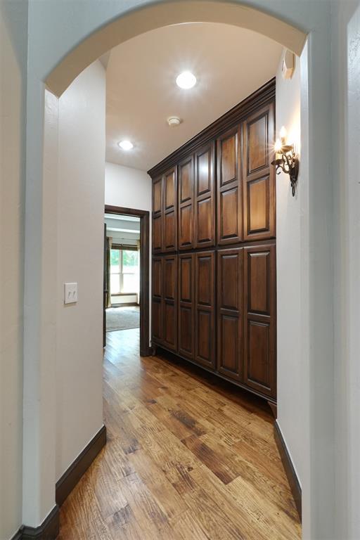 2309 Pinehurst Ct, Shawnee, OK 74801 - hallway with arched walkways, light wood-style floors, and recessed lighting