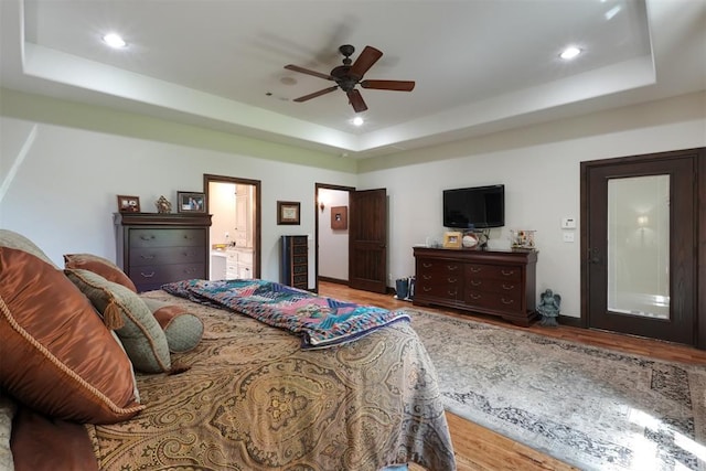 2309 Pinehurst Ct, Shawnee, OK 74801 - bedroom with a raised ceiling, wood finished floors, recessed lighting, connected bathroom, and ceiling fan