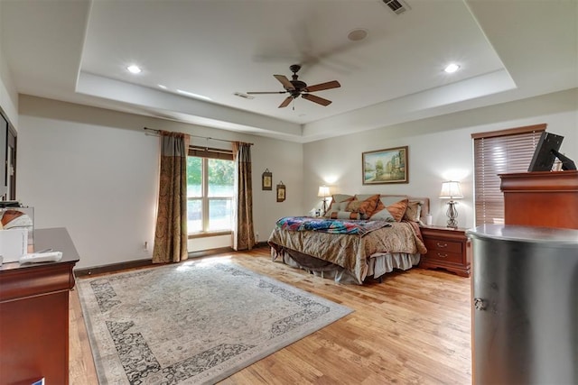 2309 Pinehurst Ct, Shawnee, OK 74801 - bedroom with a tray ceiling, light wood-type flooring, recessed lighting, and a ceiling fan