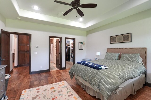 2309 Pinehurst Ct, Shawnee, OK 74801 - bedroom with a tray ceiling, wood finished floors, a walk in closet, a closet, and recessed lighting