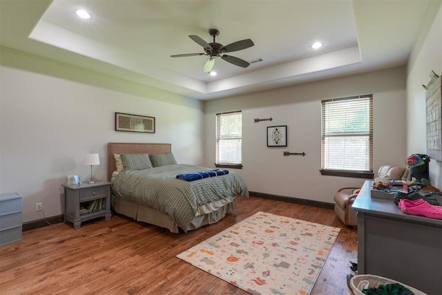 2309 Pinehurst Ct, Shawnee, OK 74801 - bedroom featuring a tray ceiling, wood finished floors, recessed lighting, and a ceiling fan