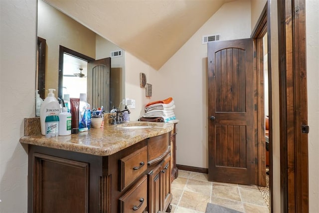2309 Pinehurst Ct, Shawnee, OK 74801 - bathroom featuring vanity, stone finish floors, and lofted ceiling