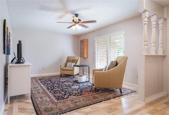 1825 Kings Rd, Edmond, OK 73013 - living area featuring a ceiling fan, wood finished floors, and a textured ceiling