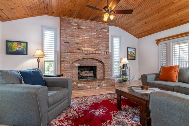 1825 Kings Rd, Edmond, OK 73013 - living area featuring vaulted ceiling, wooden ceiling, a ceiling fan, a brick fireplace, and wood finished floors