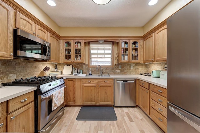 1825 Kings Rd, Edmond, OK 73013 - kitchen featuring appliances with stainless steel finishes, light wood finished floors, light countertops, and recessed lighting